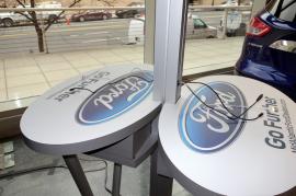 Cell Phone Charging Stations with Dual Monitors and Graphics at Auto Dealership -- Image 1