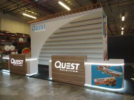 Custom Island Exhibit with Custom Counters, LED Perimeter Lighting and Logos, Locking Storage, Product Shelves, and Reception Counter