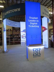 Custom Island Exhibit with (4) Lightbox Towers, (2) Counters, (4) Monitor Mounts, and Curved Headers with Pillowcase Fabric Graphics