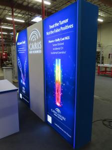 Gravitee Modular Backlit Exhibit with Tension Fabric Graphics, Backlit Press Thru Logo, and Reception Counter with Locking Storage -- View 2