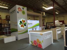 Custom Island Exhibit w/ Custom Counters, Backlit Graphics, Waterfall Accents, Locking Storage, and Halo Lit Logos