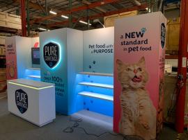 RENTAL: Custom Inline Gravitee System Design with (6) 53" Wide x 12" Deep White Laminated Shelves with LED Lighting, (2) LED Arm Lights, (1) Large Monitor Mount, 55" Monitor, (1) RE-1595 Reception Counter with Recessed LED/RGB Lighting, SEG Fabric Graphic