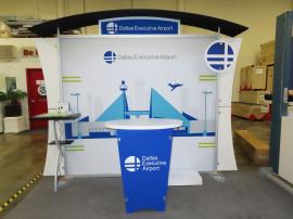 VK-1232 Sacagawea Portable Display with Tension Fabric Graphics, Canopy, Header, Circle Standoff Sign, Backwall Counter w/ Wireless Charging, Hostess Shelf, Wings, Monitor Mount, and LTK-1001 Modular Counter