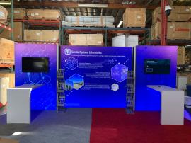 RENTAL: Modified RE-2138 Inline Design with (1) 110" Wide x 96" High Single-Sided Lightbox, (2) 60" Wide x 96" High Left & Right Single-Sided Lightboxes, (2) 12" Wide x 96" High Return Panels, (2) Large Monitor Mounts, (2) RE-1602 Waterfall Workstation Co