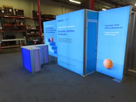 Modified Modular VK-2995 SuperNova Lightbox Inline with SEG Fabric Graphics, MOD-1702 Reception Counter with Backlit Graphics, Wireless Charging Pads, and Locking Storage, and Locking Closet Door