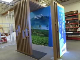 Reconfigurable Island to 10 x 20 Inline with Full-size Closet, Tension Fabric Graphics, (2) Double-sided SuperNova Lightbox, Monitor Mount, Slat Ceiling, and Custom Reception Counter