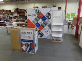 Modified ECO-1070 Sustainable Exhibit with Aluminum Extrusion Frame, Backlit Tension Fabric Graphic, Modifed ECO-35C Counter with Locking Storage, (3) Angled Product Shelves, and Monitor Mount -- View 3