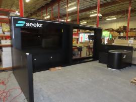 Custom Wood Inline Exhibit with Push Thru Backlit Logos, Large Monitor Mount, Opening for LED Video Tiles, RGB LED Accent Lights, and Custom Reception Counter with Locking Storage -- View 2