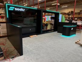 Custom Wood Inline Exhibit with Push Thru Backlit Logos, Large Monitor Mount, Opening for LED Video Tiles, RGB LED Accent Lights, and Custom Reception Counter with Locking Storage