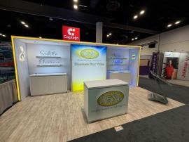 RENTAL: Custom Gravitee Inline Design with White Laminated Canopy, Center Bump-Out, (2) RE-1595 White Laminated Workstation Counters with Recessed RGB Accent Lighting, RE-1576 White Laminated Reception Counter with Recessed RGB Accent Lighting, Edge Light