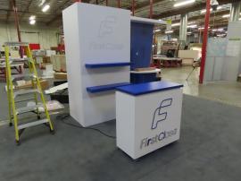 Modified VK-1132 Custom Exhibit with Backwall Counter, Storage Closet, Shelves, Monitor Mount, Backlit Logos, and MOD-1581 Counter with Locking Storage