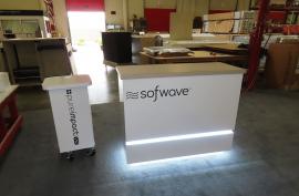 Custom Display Counters. (1) Reception Counter with LED Accent Lights, Vinyl Graphic and Locking Storage. (2) Product Display Counter with Grommet, Vinyl Graphic, and Castor Wheels