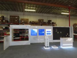 Custom Reconfigurable Inline Exhibit with Full-size Closet, Backlit Logos, Lightboxes, Reception Counter with LED Accent Lights, Riser, Product Display, and Opening for LED Video Tiles -- View 2